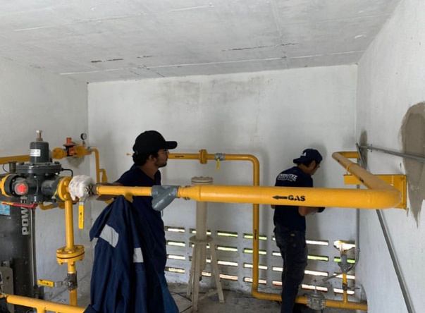 Tenova technicians installing gas piping on site